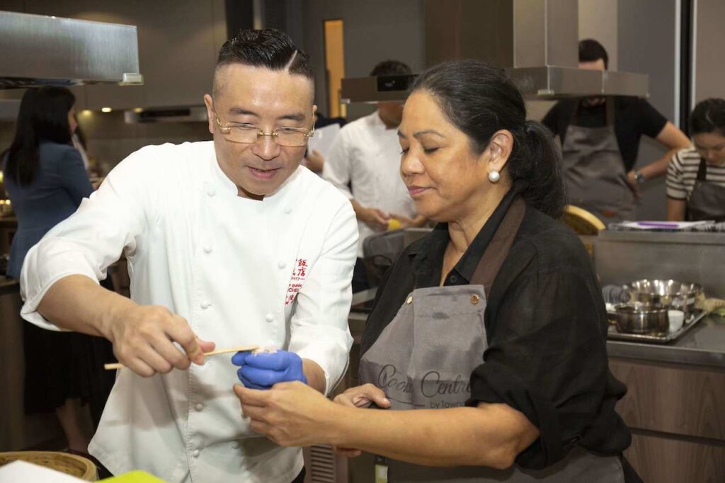 Chef Adam Wong assists Chef Gaita Fores during a dimsum workshop
